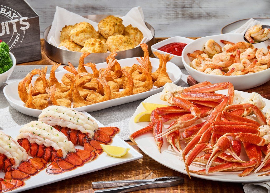 Catering spread with lobster tails, snow crab legs, shrimp, and Cheddar Bay Biscuits